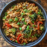 Sizzling chicken ramen stir fry with bright vegetables and glossy noodles