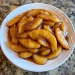 Fried apples served warm with a pat of butter melting